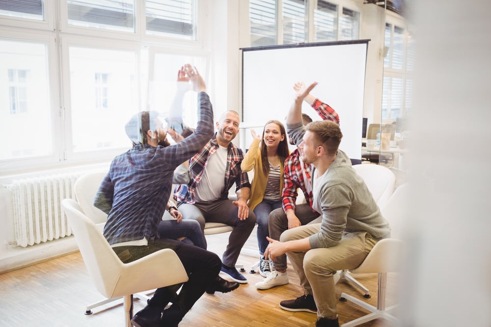 five agency team members high-fiving