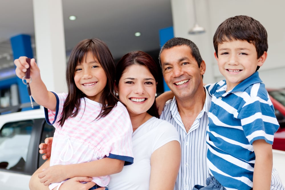 family of four just purchased a car at a dealership