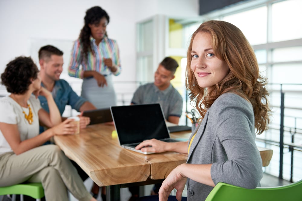 woman at laptop with colleagues