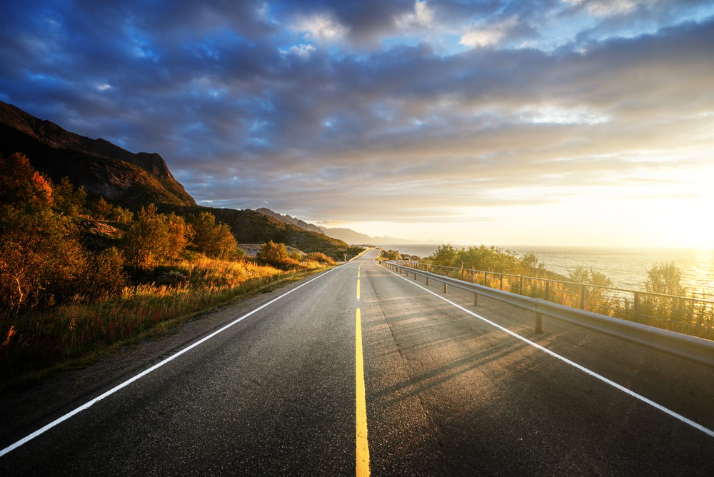 two lane road under cloudy skies